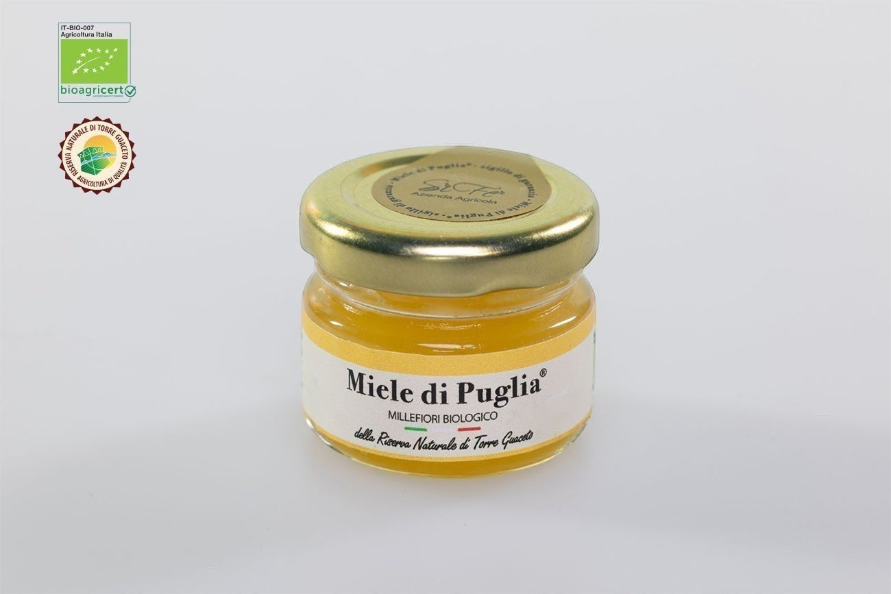 Vasetto di Miele Millefiori Biologico di Puglia Agricolasifè dal colore dorato con tappo dorato su sfondo neutro